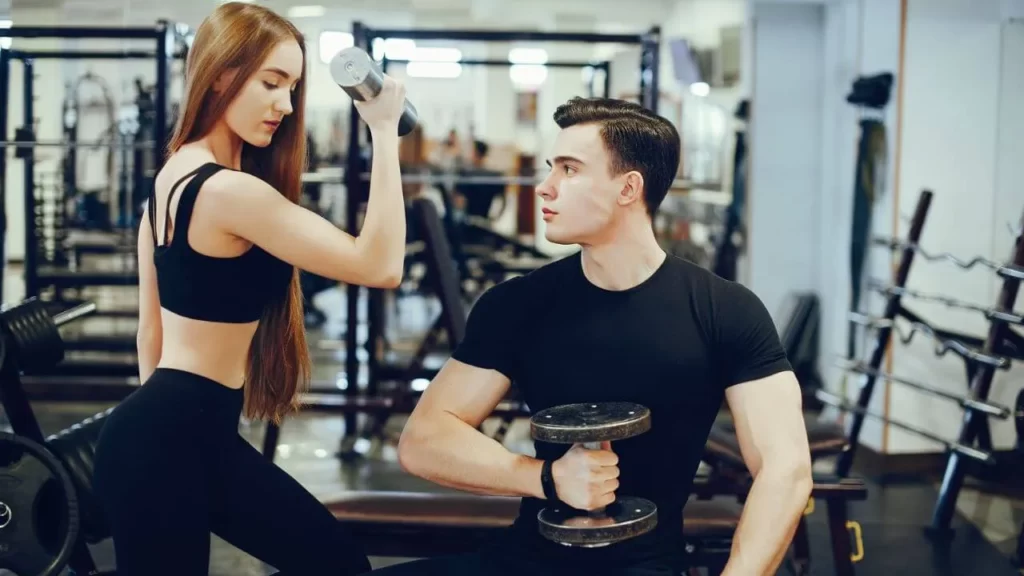 Image of a woman and man training in a gym
