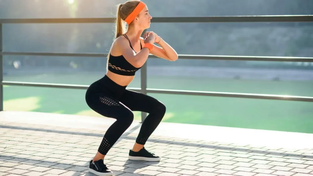 Image-of-a-woman-doing-a-squat-stretch.