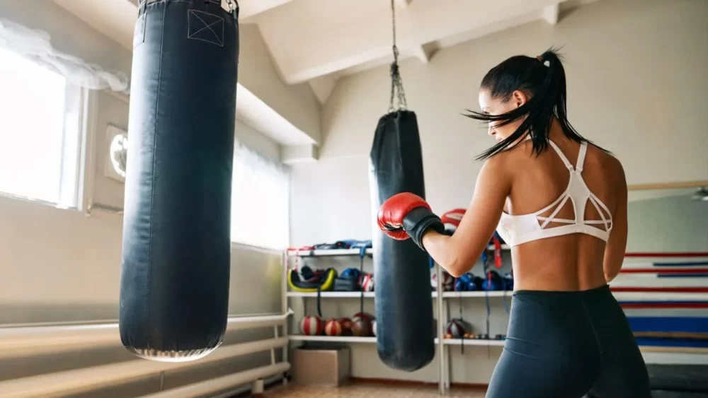 Image-of-a-woman-practicing-punching-with-a-sandbag.