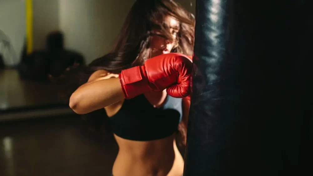Image-of-a-woman-practicing-a-right-hook-on-a-sandbag